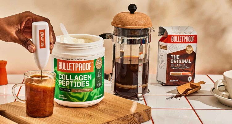 Collagen Peptides being frothed in mug next to Original Coffee and a french press