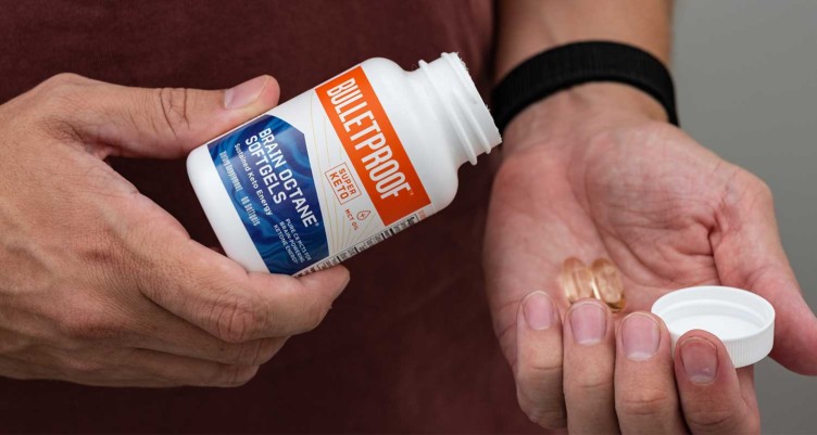 Man pouring Bulletproof Brain Octane Soft Gels into hand