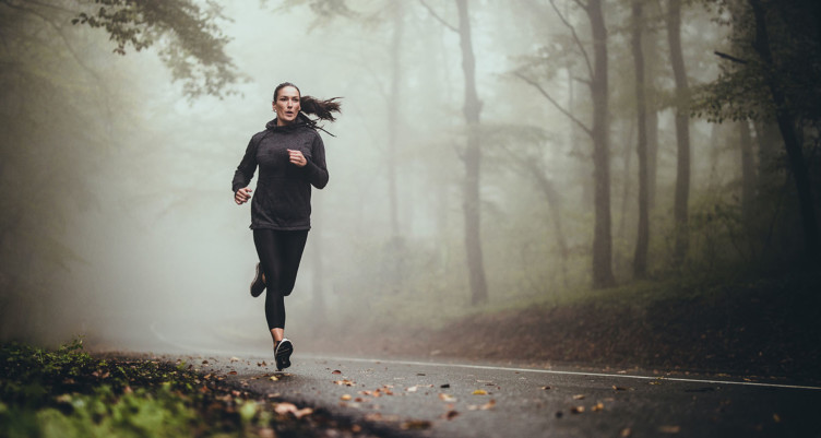 Woman running on a foggy day