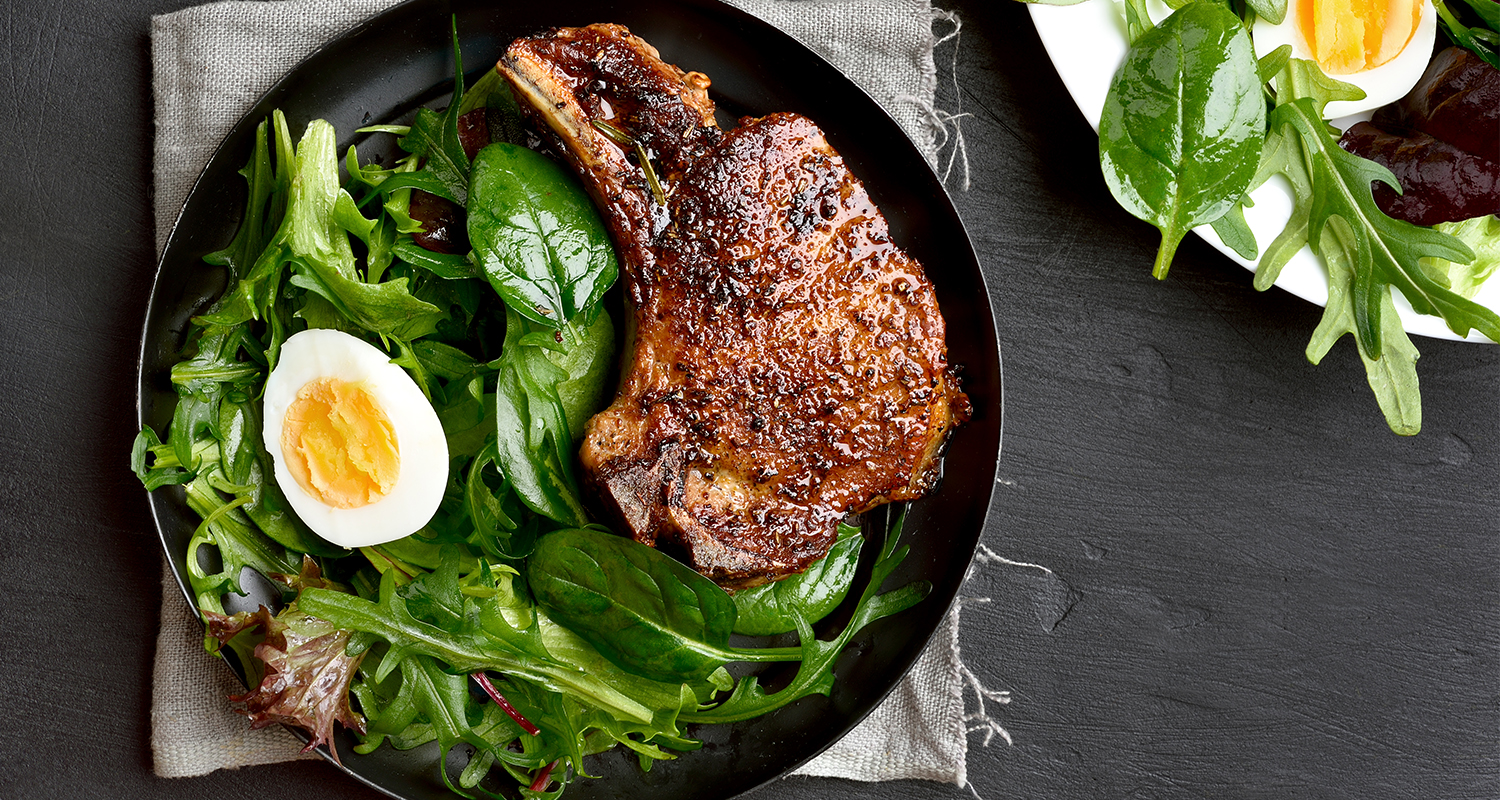 Grilled pork steak with green salad.