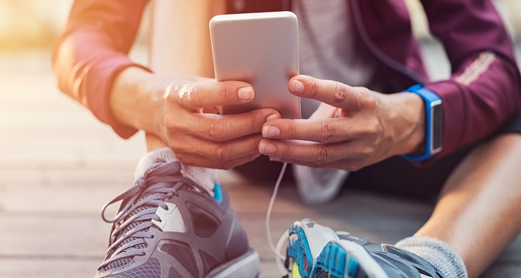 A person getting ready to run with a smartphone