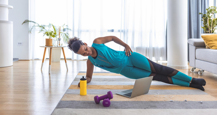 A black woman working out from home