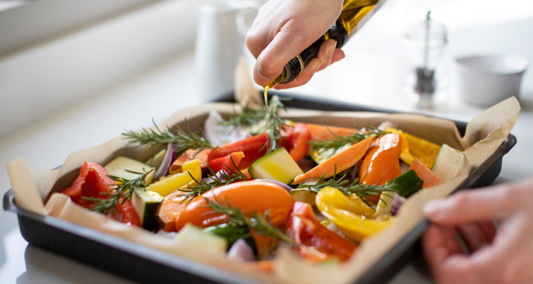A tray of roasted vegetables with oil