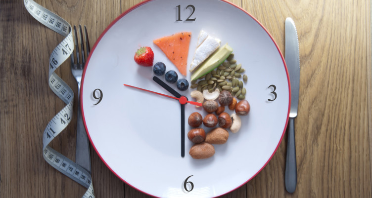A plate shaped like a clock with some food
