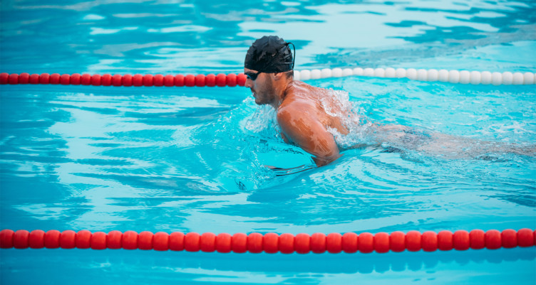 A person swimming in a lap pool