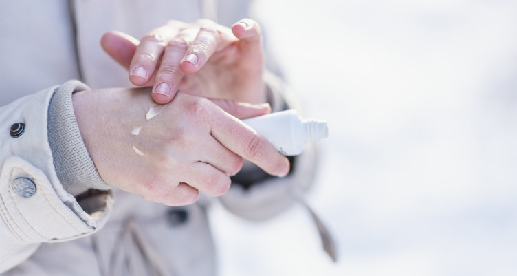 Woman putting lotion on hands