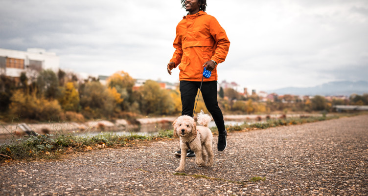 A man walking his dog outdoors