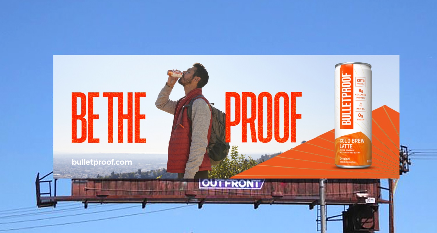 A Be The Proof Billboard featuring a man drinking Bulletproof Cold Brew Latte