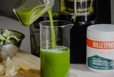 A glass of green juice with Bulletproof InnerFuel Prebiotic