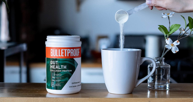 A scoop of Bulletproof Gut Health dropping into a mug