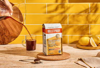 Bulletproof Breakfast Blend Ground coffee bag on counter with mug of coffee