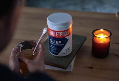 A person drinking a Bulletproof Sleep Collagen Protein tonic by candlelight