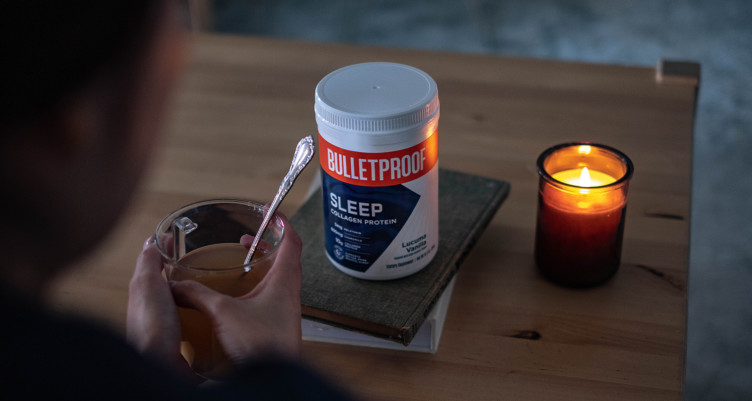 A person drinking a Bulletproof Sleep Collagen Protein tonic by candlelight
