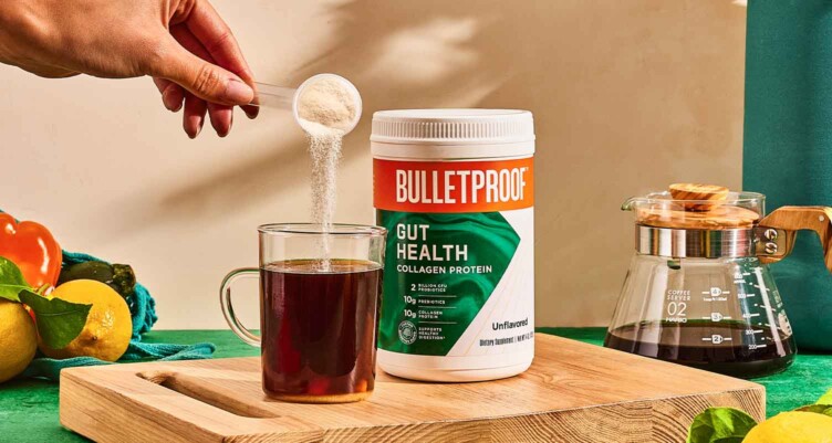 A scoop of Bulletproof Gut Health being poured into a coffee mug