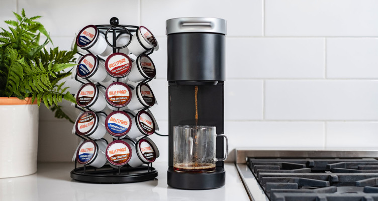 Bulletproof single-serve coffee pods next to a single-serve coffee machine