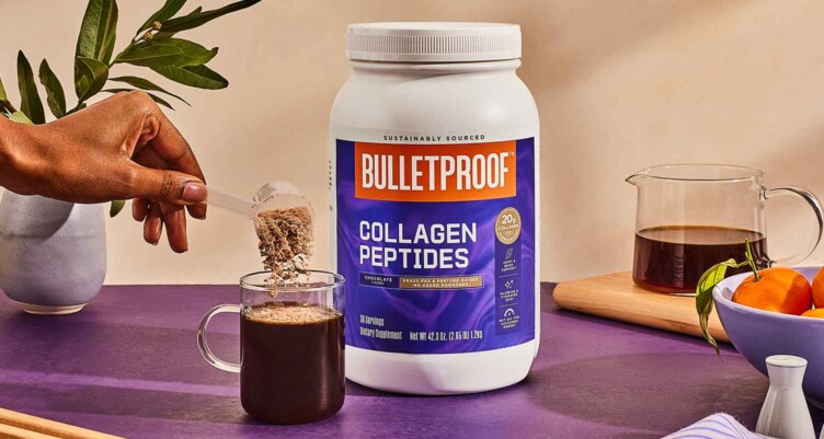 Hand scooping Chocolate Collagen into coffee on purple counter