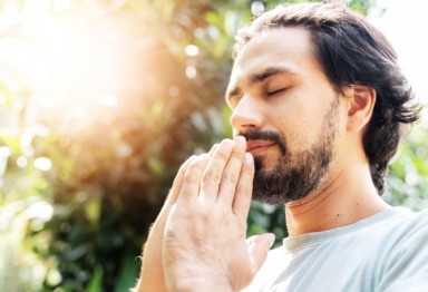 Man meditating outdoors.