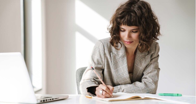 Woman sitting at desk wearing a blazer