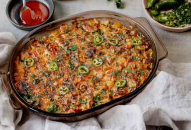 Large dish of Keto Buffalo Chicken Casserole surrounded by it's ingredients