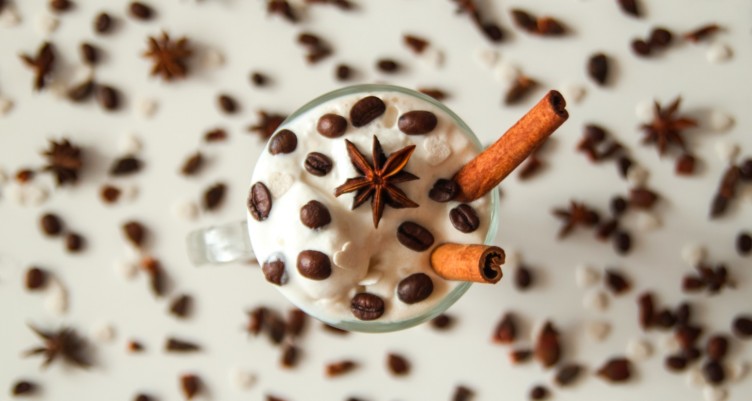 Overhead image of vanilla coffee shake with coffee bean accents