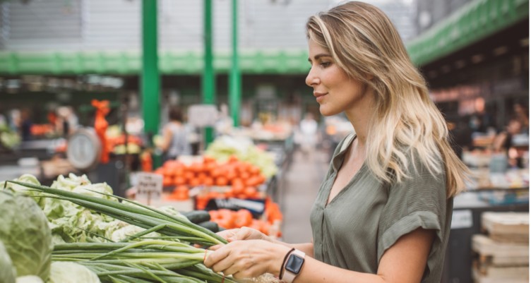 Woman shopping for vegetables at a farmers market