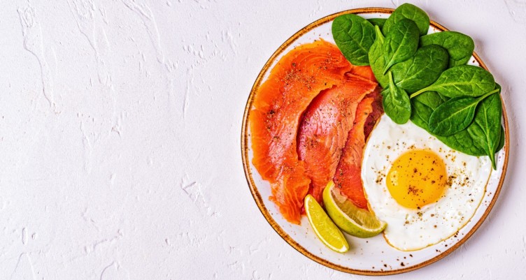 A breakfast plate of salmon, eggs and spinach
