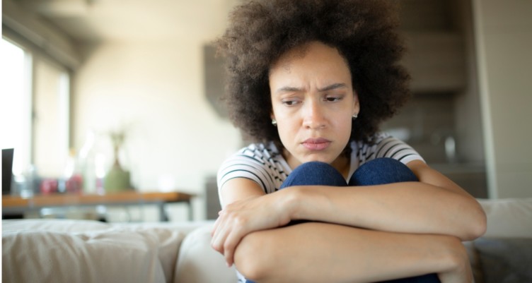 Sad woman sitting alone.