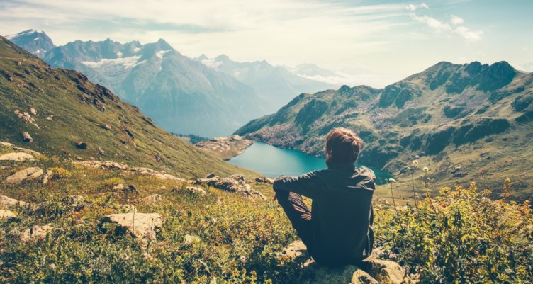 Man sitting on mountains.