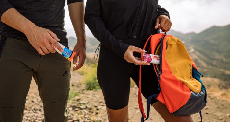 Two people hiking and holding Bulletproof Collagen Protein Bars