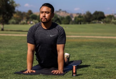 A man doing yoga in a park