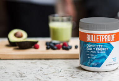 A tub of Bulletproof Complete Daily Energy Collagen Protein and smoothie ingredients
