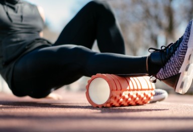 Man using a foam roller on his right calf