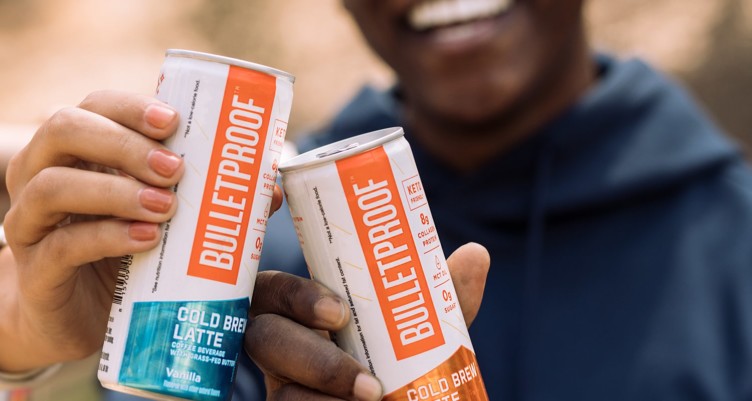 Toasting with two cans of Bulletproof Cold Brew Latte