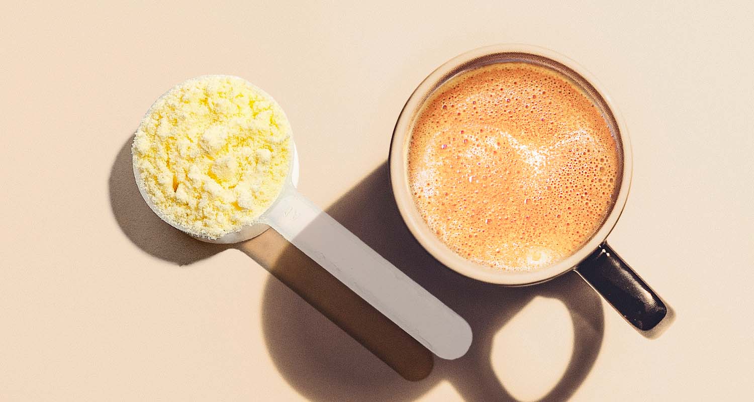 A scoop of powdered coffee creamer and a cup of coffee