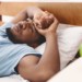 Man in bed suffering from insomnia and sleep disorder