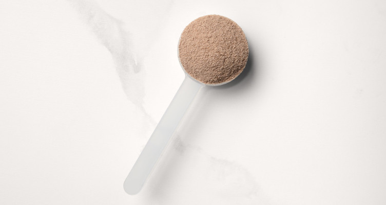 A scoop of Dark Chocolate Complete Daily Energy Collagen Protein powder