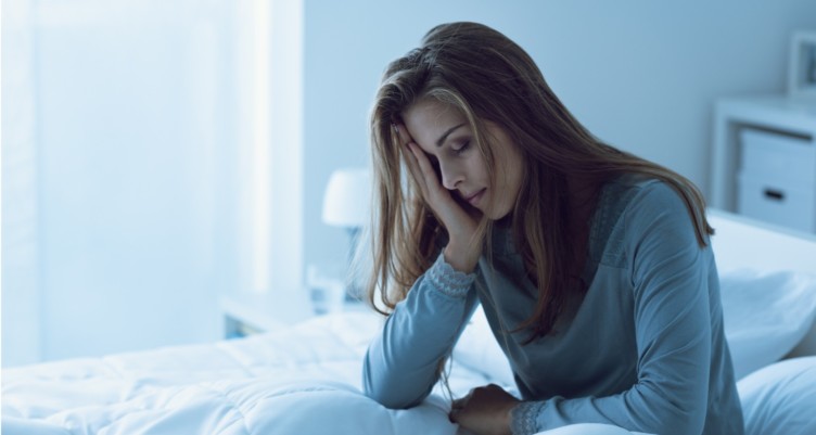 Woman awake in the night resting her head on her hand