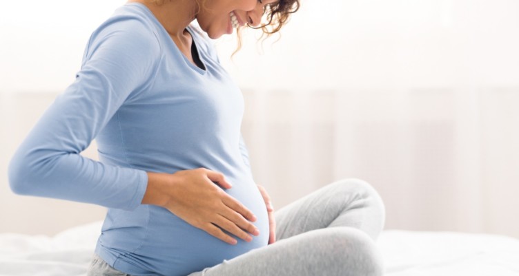 Pregnant woman touching her belly