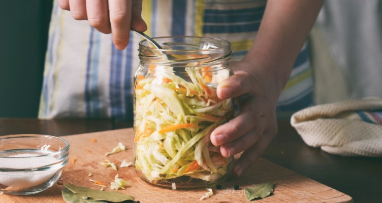 Woman making sauerkraut at home.
