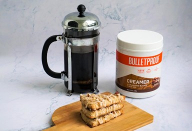 A French press, a stack of scones and a tub of Bulletproof Hazelnut Creamer