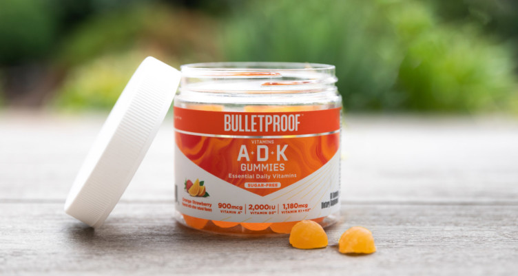 A jar of Bulletproof A+D+K Gummies with the lid removed