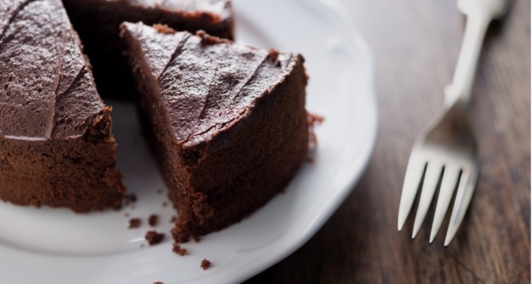 Sliced chocolate cake on white plate