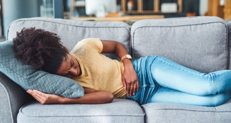 Woman laying down with stomach ache