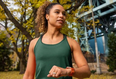 Woman with a fitness watch standing outside