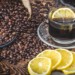 Coffee cup and roasted coffee beans with lemon slices.