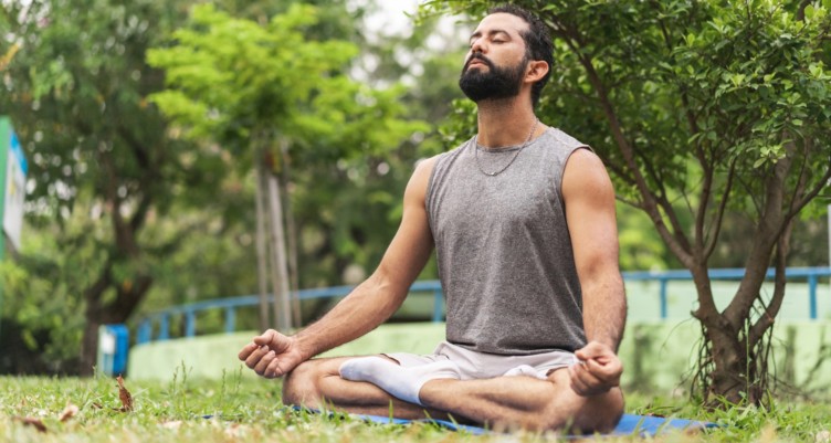 A man meditating in the park