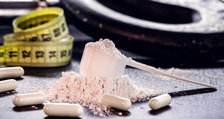 Sports supplements with weights and a tape measure.