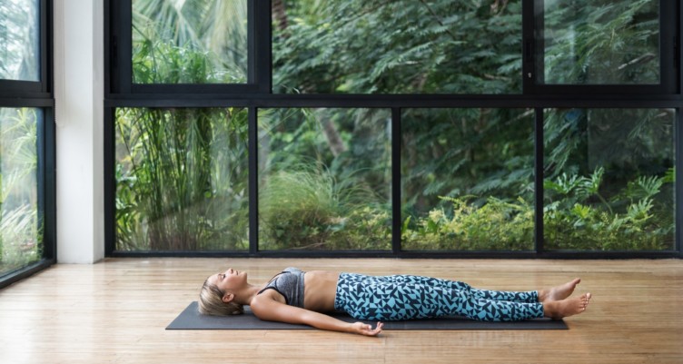 Woman practicing yoga at a gym club.