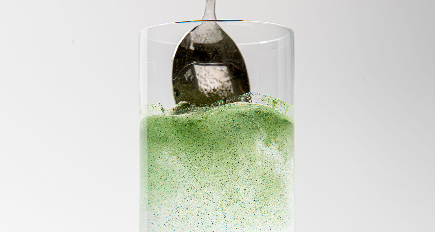 greens mixing into water