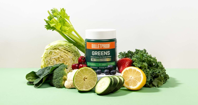 Bulletproof Greens surrounded by fruits and vegetables.